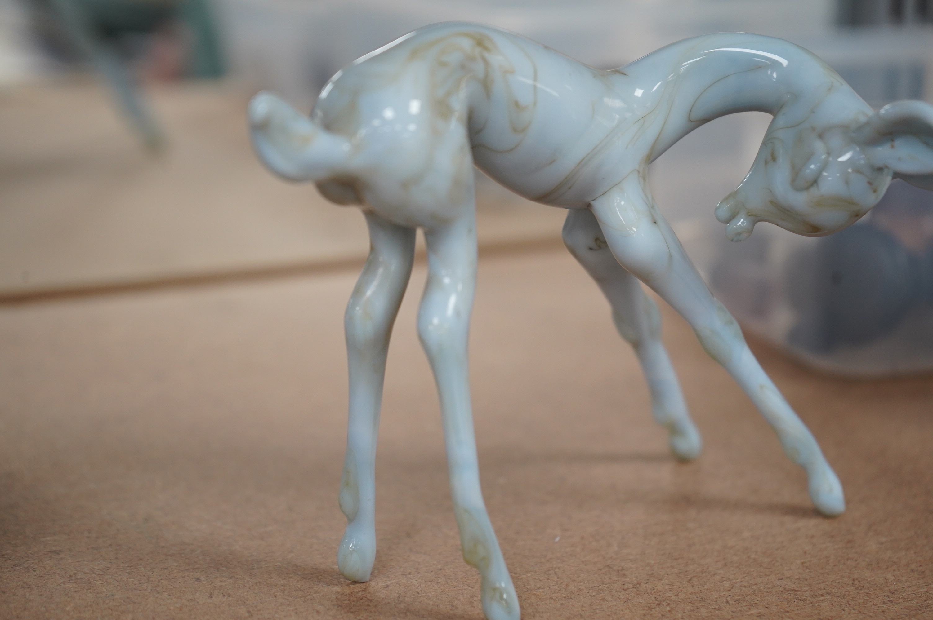 A group of collectables comprising an Istvan Komaromy blue glass foal, 11cm high, three 19th century French faience cows, a South Staffordshire enamel box, a Minton box, eight various seals, a brass thread counter, Condi